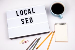 local seo text in lightbox white desk with stationery